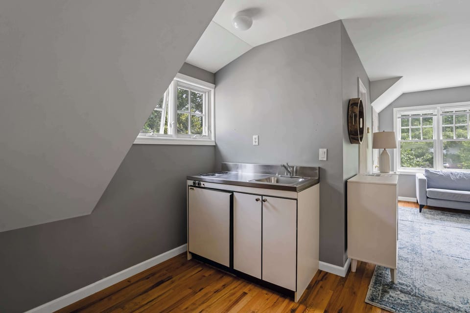 Compact kitchenette with sink and cabinets
