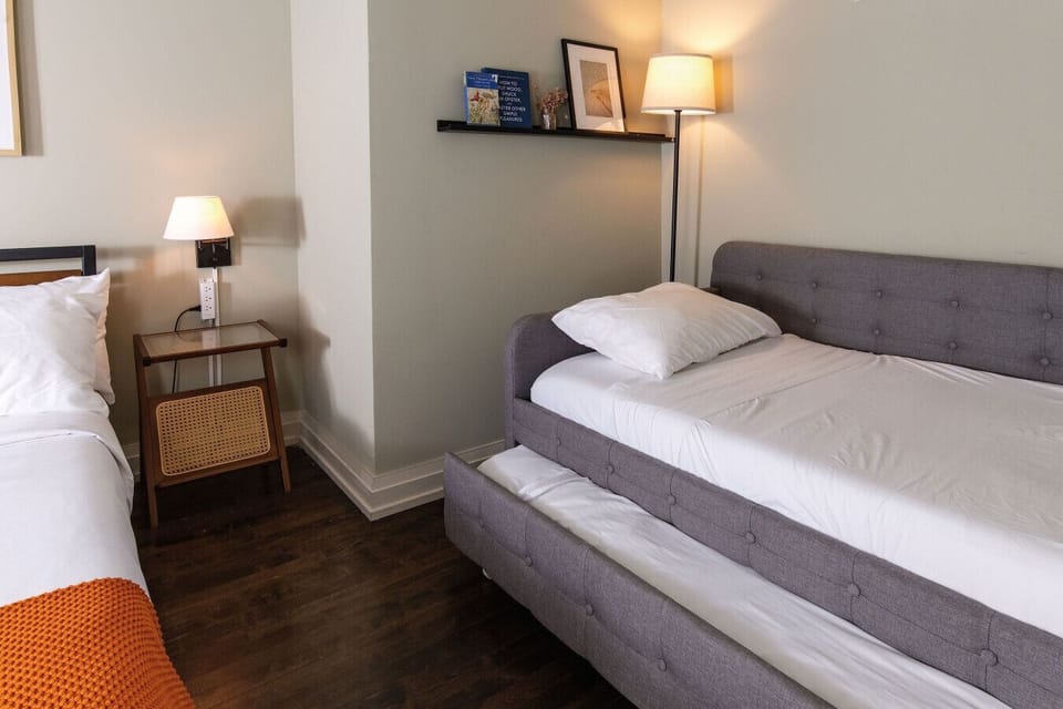 The master bedroom features an en-suite bathroom and a double Twin trundle daybed, sleeping up to four total when including the comfy queen size bed