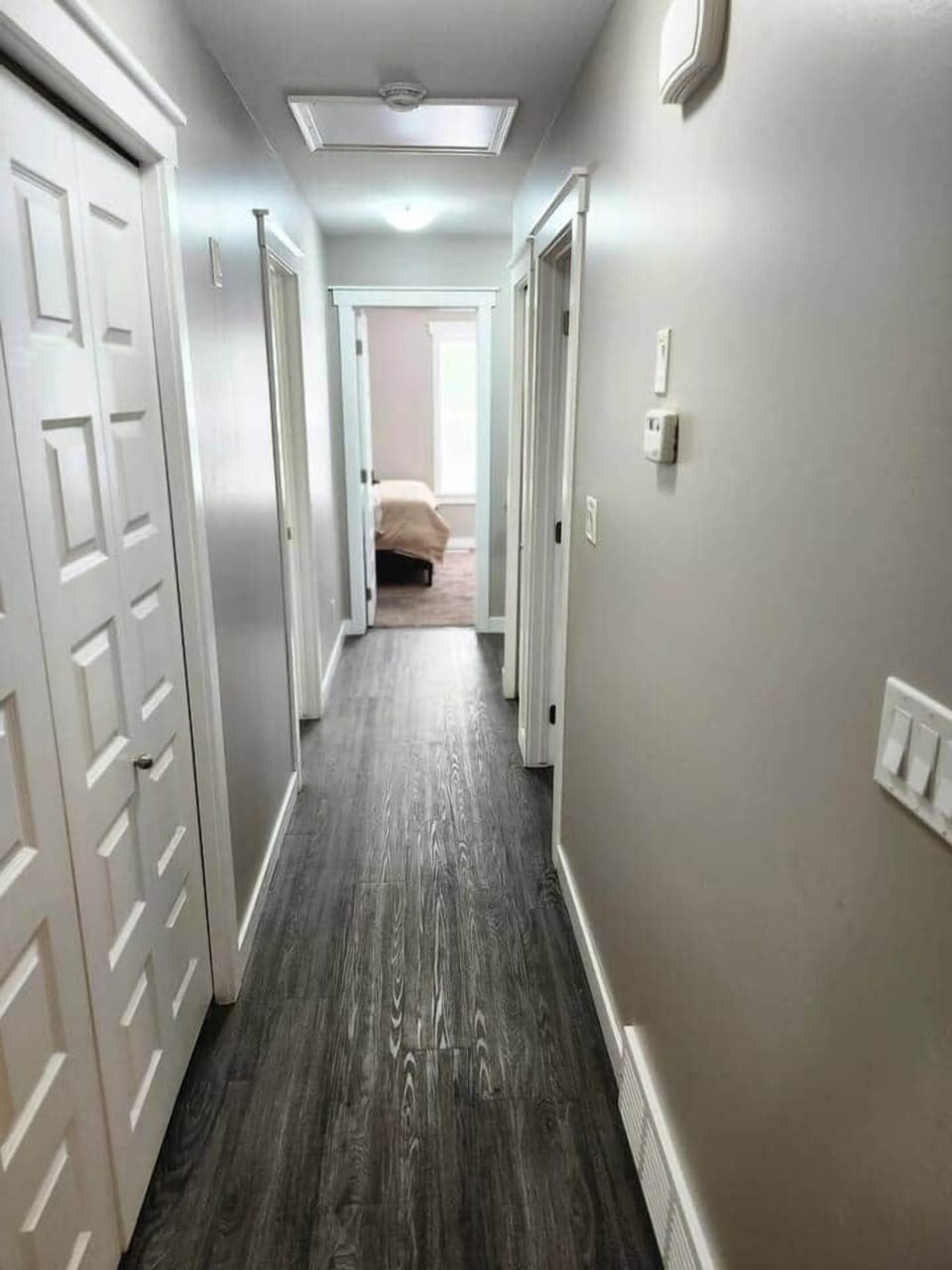 Hallway connecting bedrooms to open concept living/kitchen/dinning space.