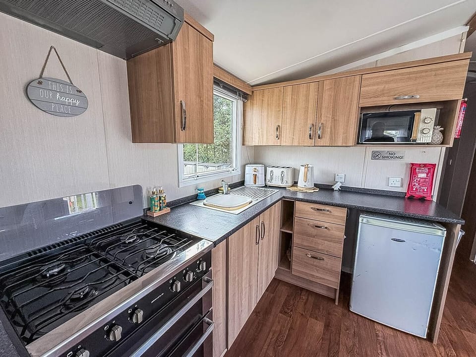 Prepare your favourite holiday meals while still being part of the conversation in this convenient open plan caravan kitchen.