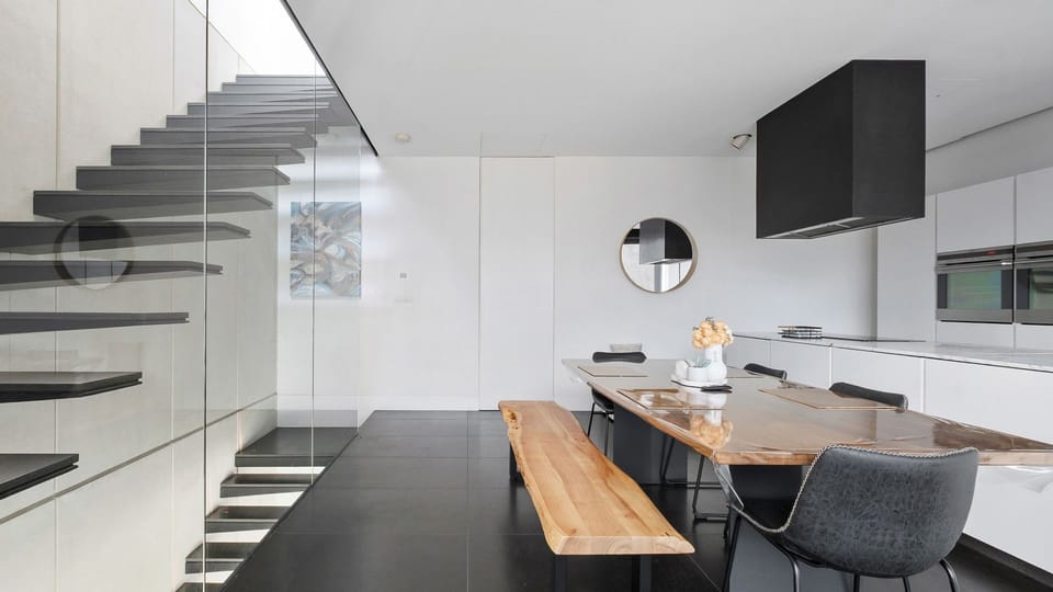 Open kitchen with a full-sized dining table ideal for shared meals.