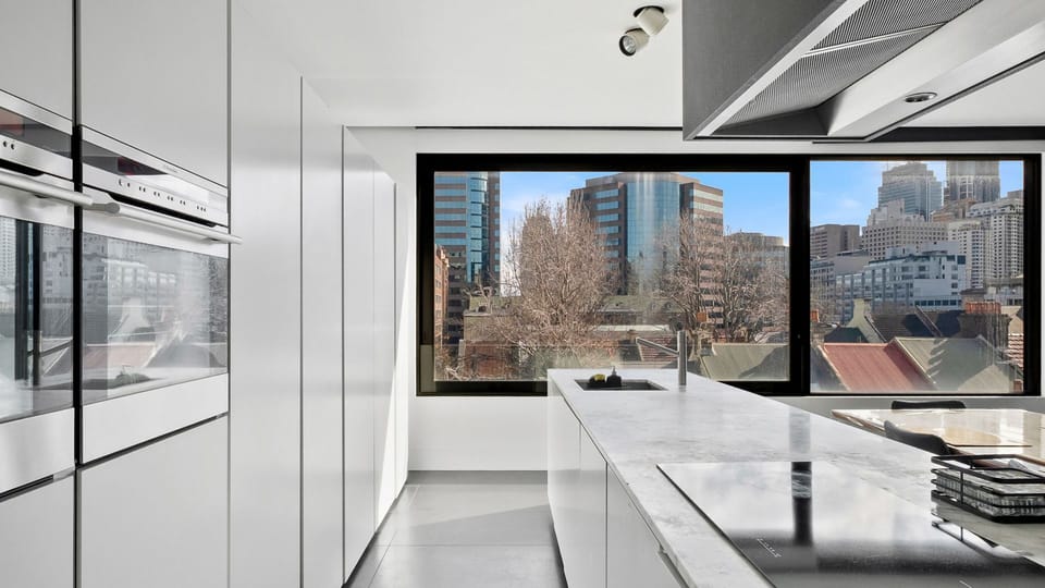 Modern kitchen fully equipped with induction cooking and essential appliances.