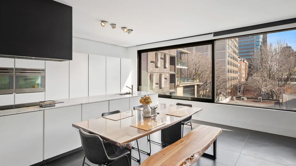 Modern kitchen with a large dining table perfect for meals at home.