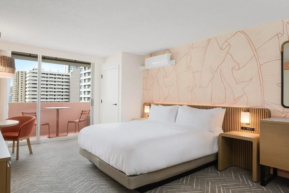 Unwind in a bright bedroom with breezy private balcony.