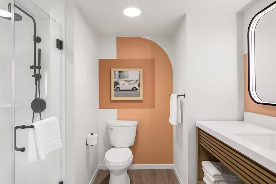 Refresh in a spotless bathroom with sleek fixtures and glass shower.