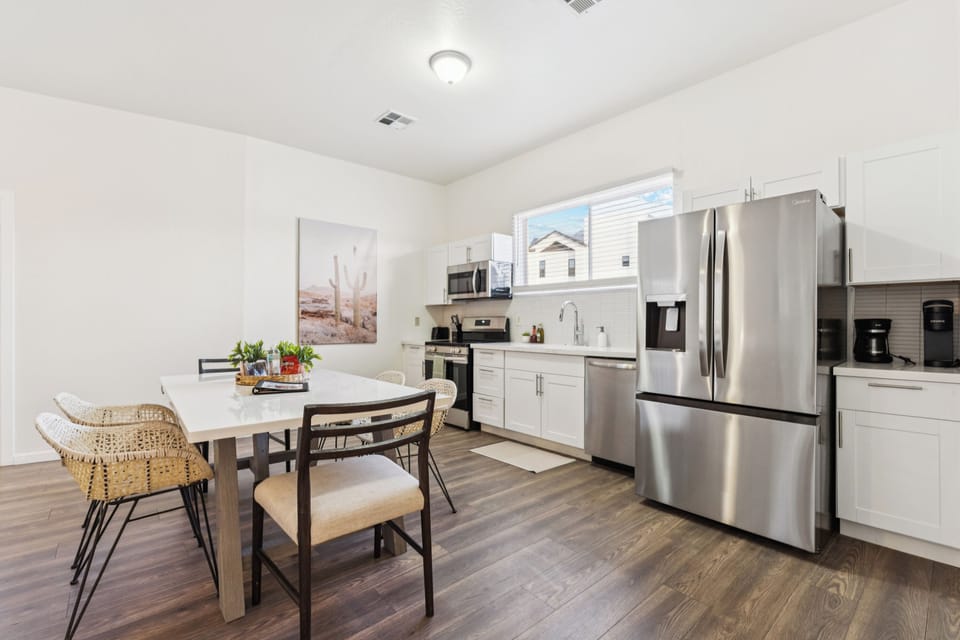 View of the upgraded kitchen with all stainless steel appliances and spacious dining area.