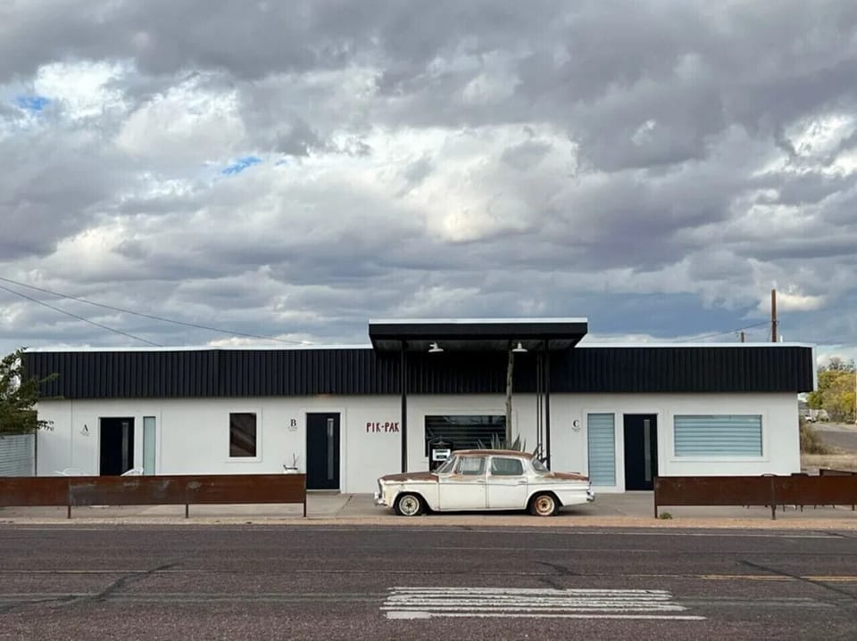 Pik Pak Marfa building exterior with vintage white car — restored 1940s service station
