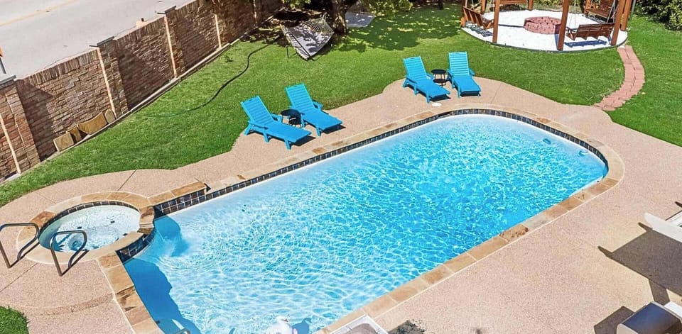 Private pool and kiddie pool with relaxing outdoor lounge area.