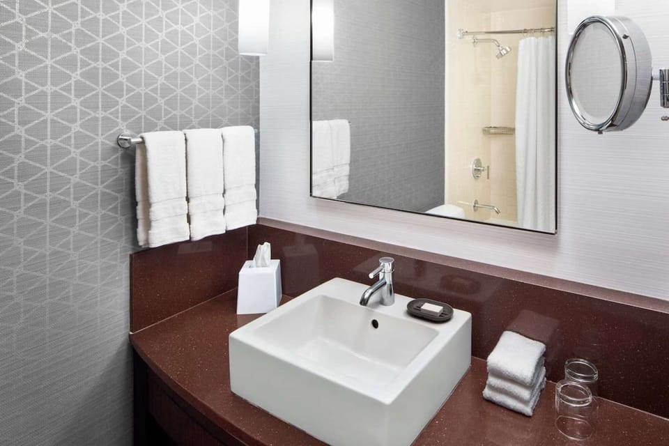 Vanity with square sink, large mirror, and soft towel rack