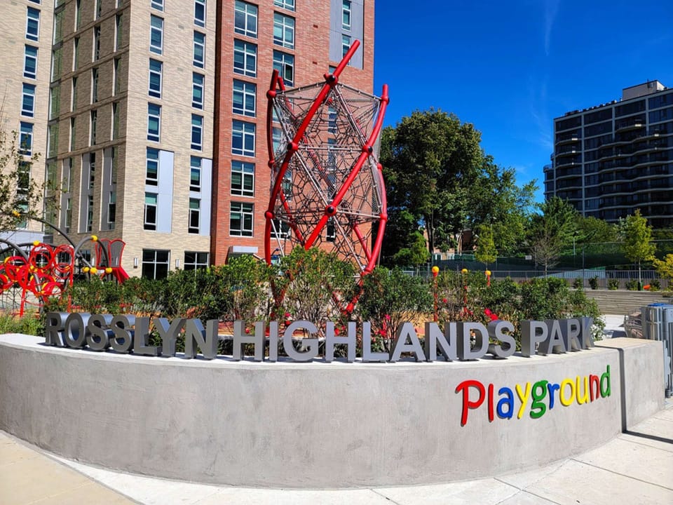 Rosslyn Highlands Park with climbing nets and colorful sign