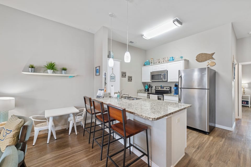 Your modern kitchen features granite countertops, stainless steel appliances, and a breakfast bar perfect for morning coffee or casual meals.