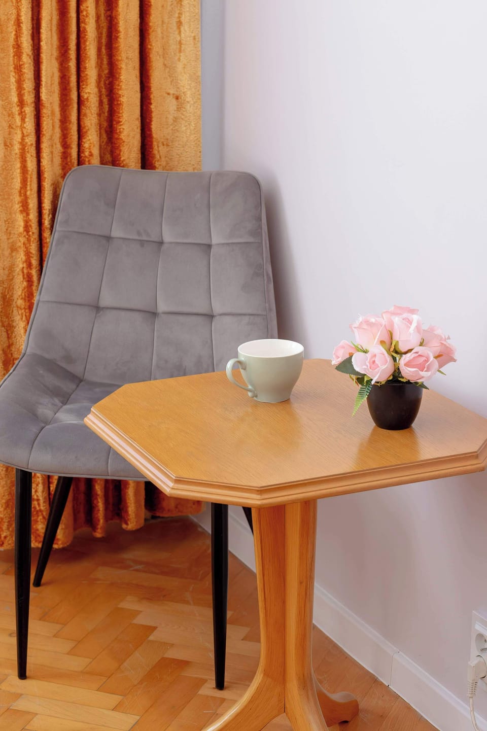 A relaxation corner with a comfortable armchair and table, ideal for morning coffee.