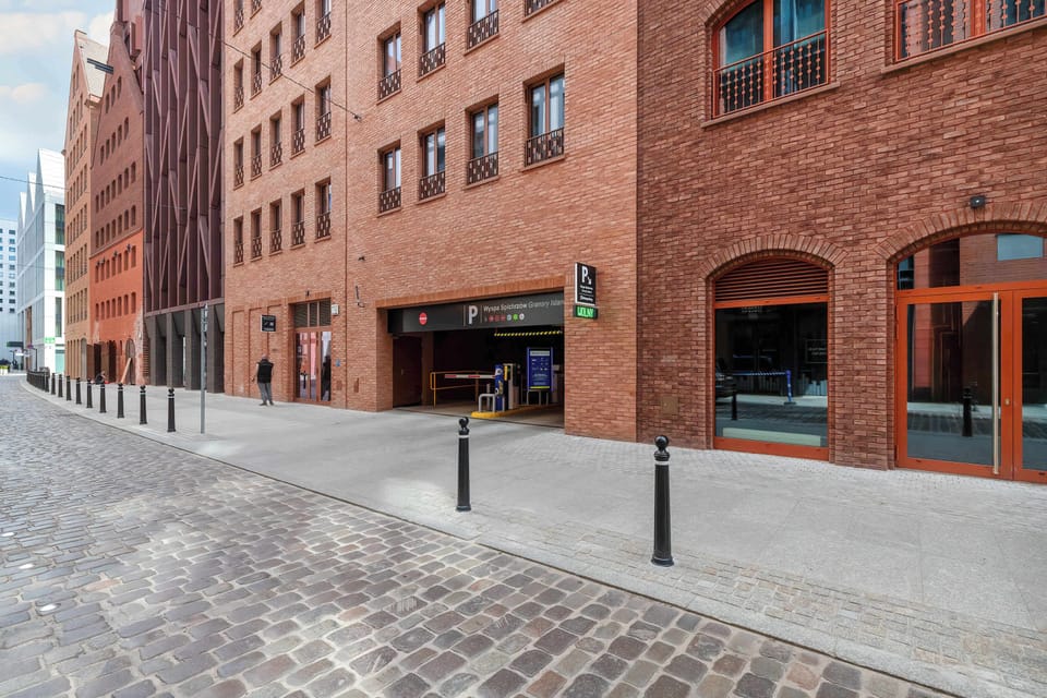 A wide entrance gate opens onto a charming courtyard that leads directly to the apartment building.

