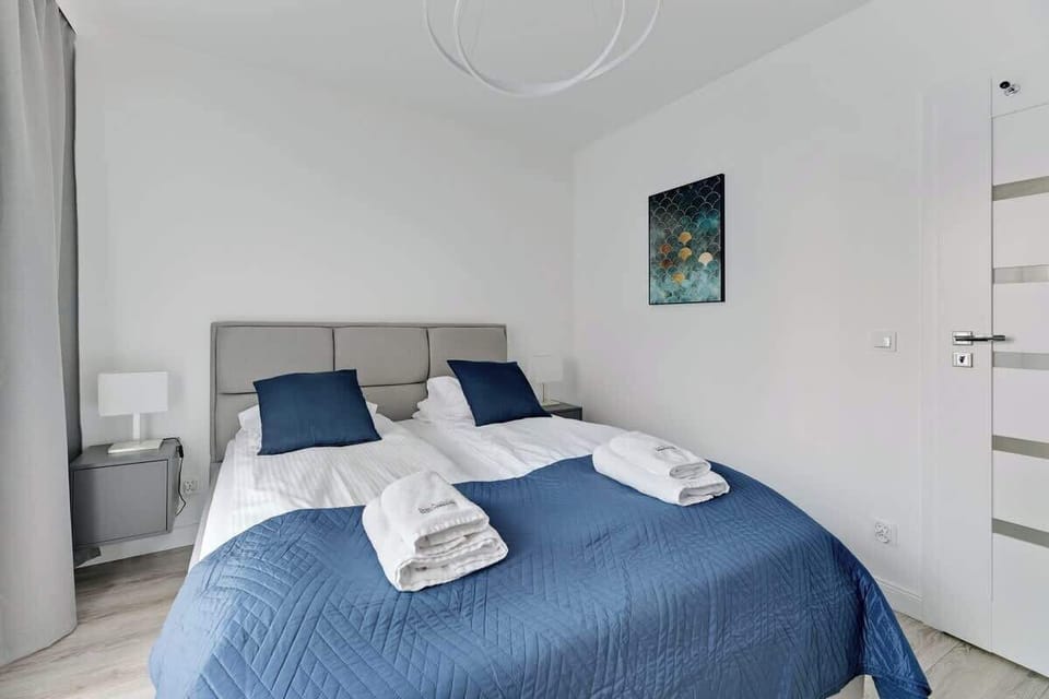 Soft blue tones, a minimalist design, and sleek contemporary furnishings, creating a tranquil and inviting atmosphere.