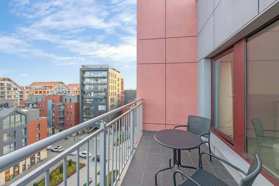 Sleek modern furniture and panoramic cityscape views, offers a sophisticated outdoor retreat in a contemporary urban setting.