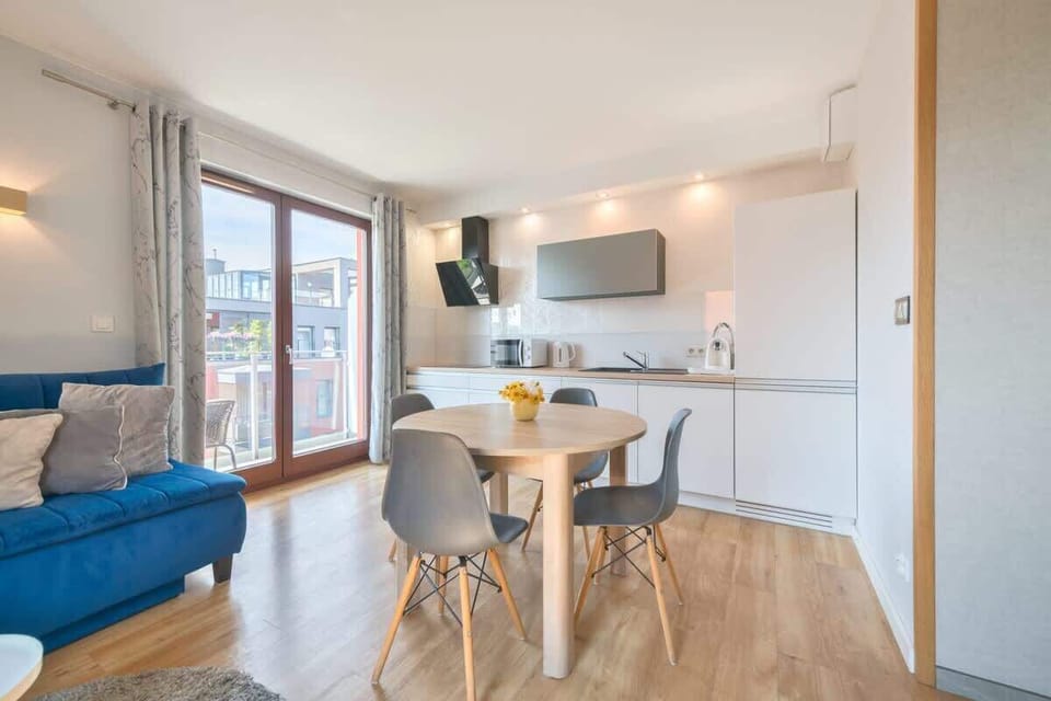 Chic vibe with a bright, airy atmosphere, featuring clean lines, modern furnishings, and a well-equipped kitchen that enhances its functional elegance.