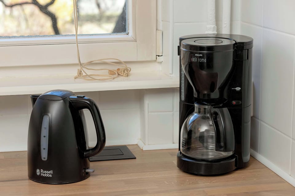 Electric kettle and coffee maker in the kitchen.
