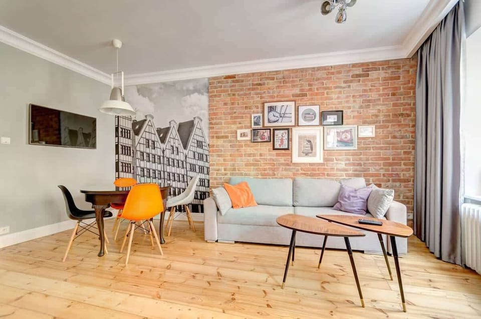 Complementing the sofa are cozy armchairs and a dining table, offering a versatile space for both unwinding and dining.