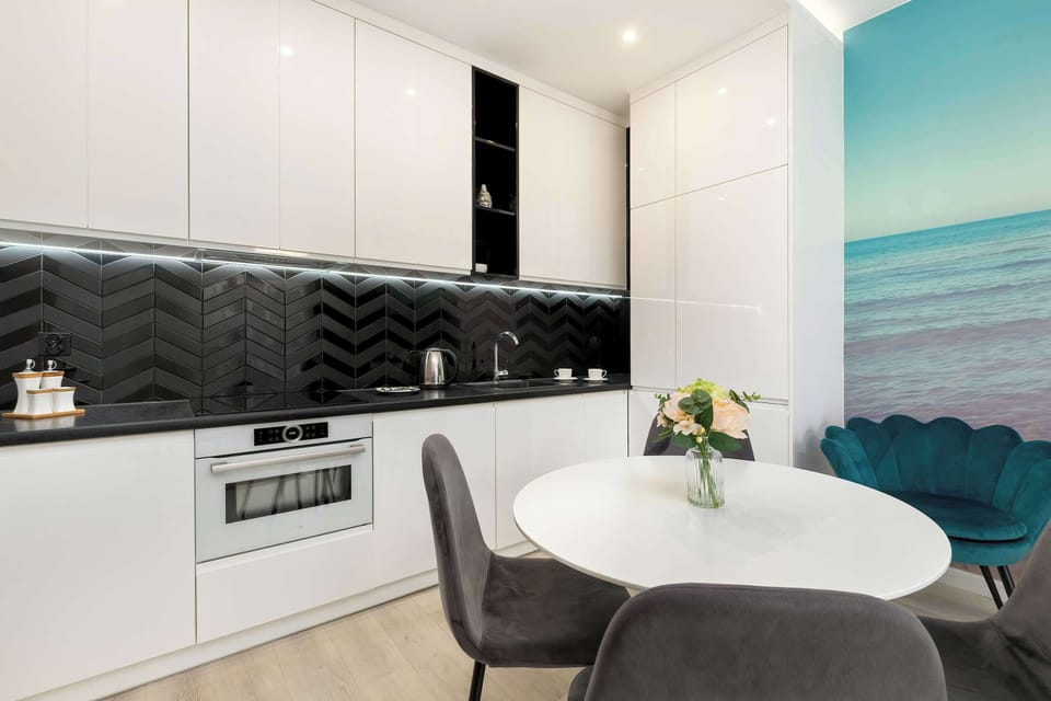 Fully equipped kitchenette with induction cooktop and dining area.