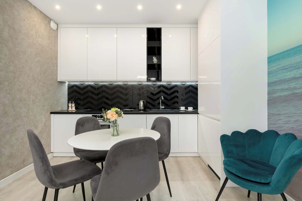 Fully equipped kitchenette with induction cooktop and dining area.