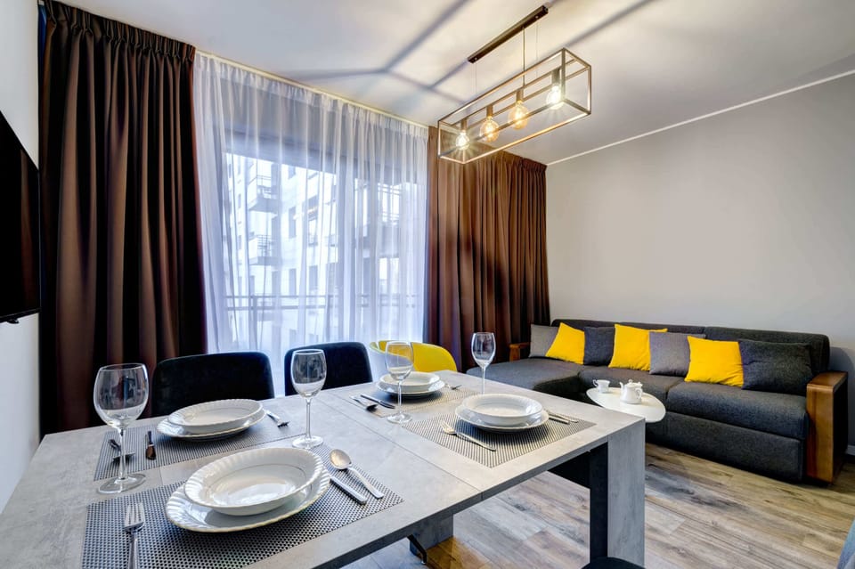 The living room's modern and stylish decor creates a welcoming atmosphere. 