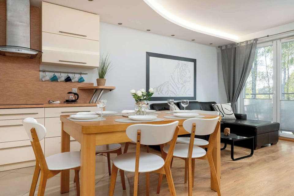 The open-plan kitchenette and dining area provide space for both cooking and enjoying meals.