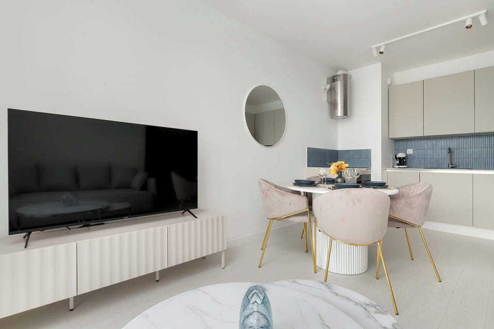 A living room with a wall-mounted TV and elegant interior decor combines functionality with aesthetics.
