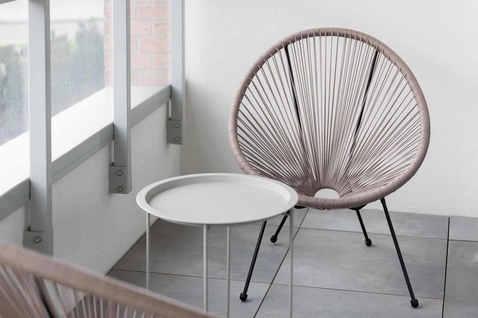 The balcony provides a serene environment for relaxation. 