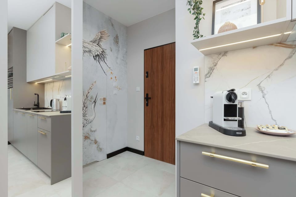 Stylish kitchenette and hallway with modern decor – Sleek and well-lit.

