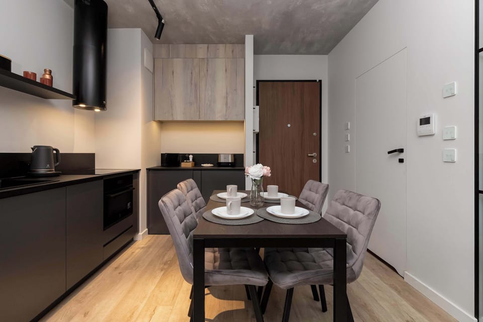 Kitchenette and dining area with table and chairs.