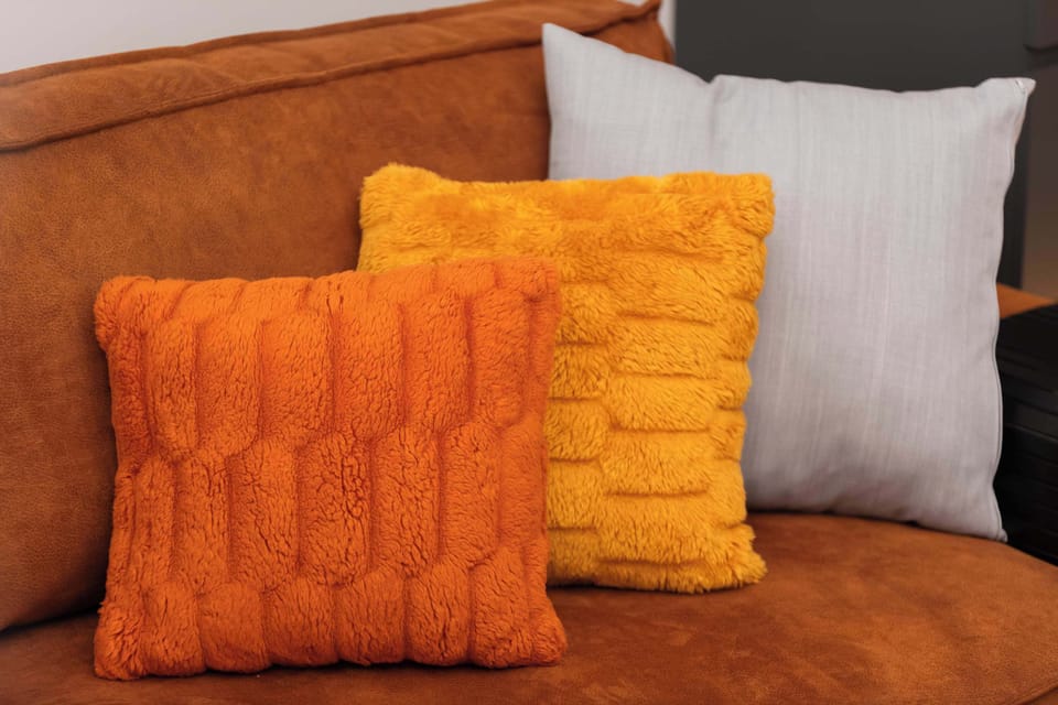 Decorative details in the form of plush cushions and sofa - comfort at every touch.