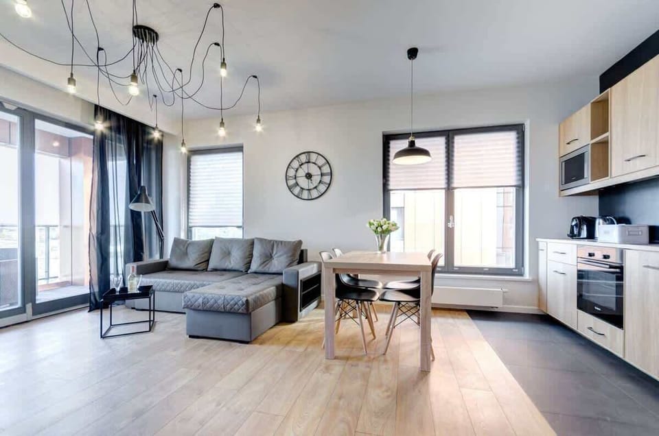 An elegant living room integrated with a functional kitchenette offers space for relaxing and spending time together.