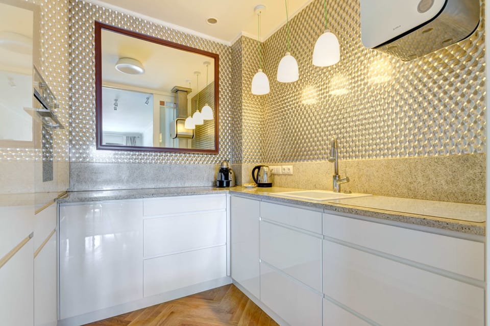 A modern and fully equipped kitchen with clean lines and a neutral color scheme.