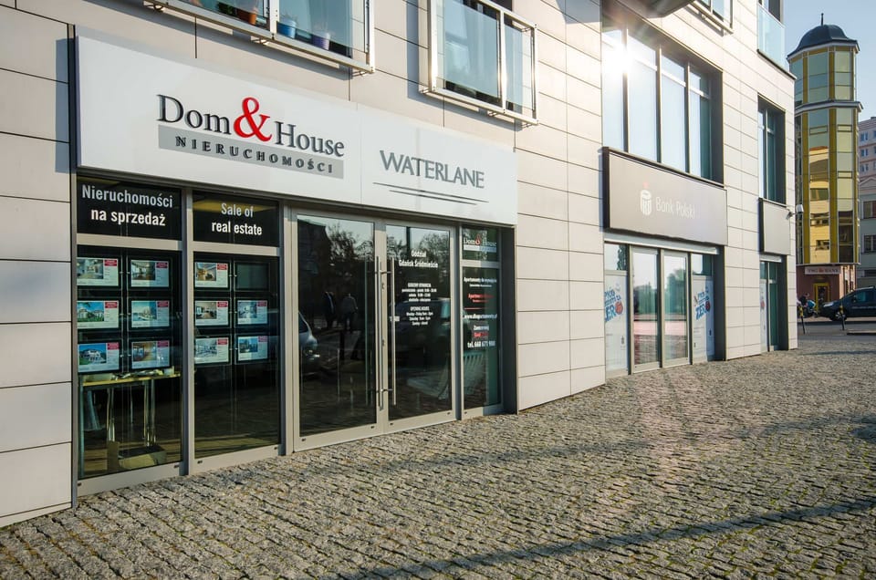 A modern office or commercial area with a contemporary design and a glass facade. Sleek, professional, and urban in style.