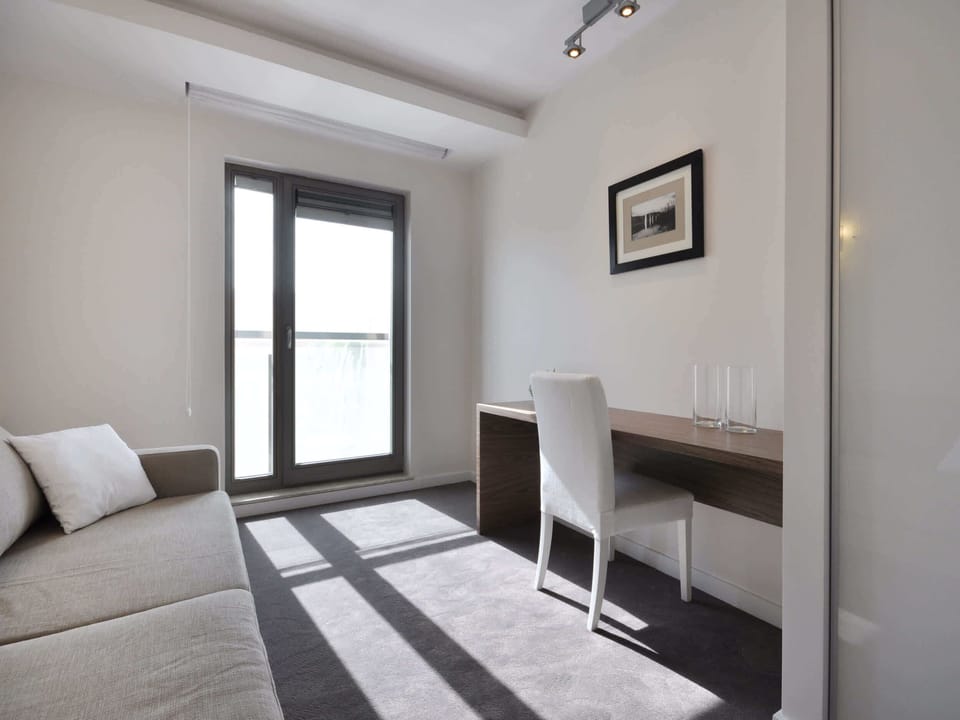  The bright colors and minimalist style give the room a light and spacious feel.