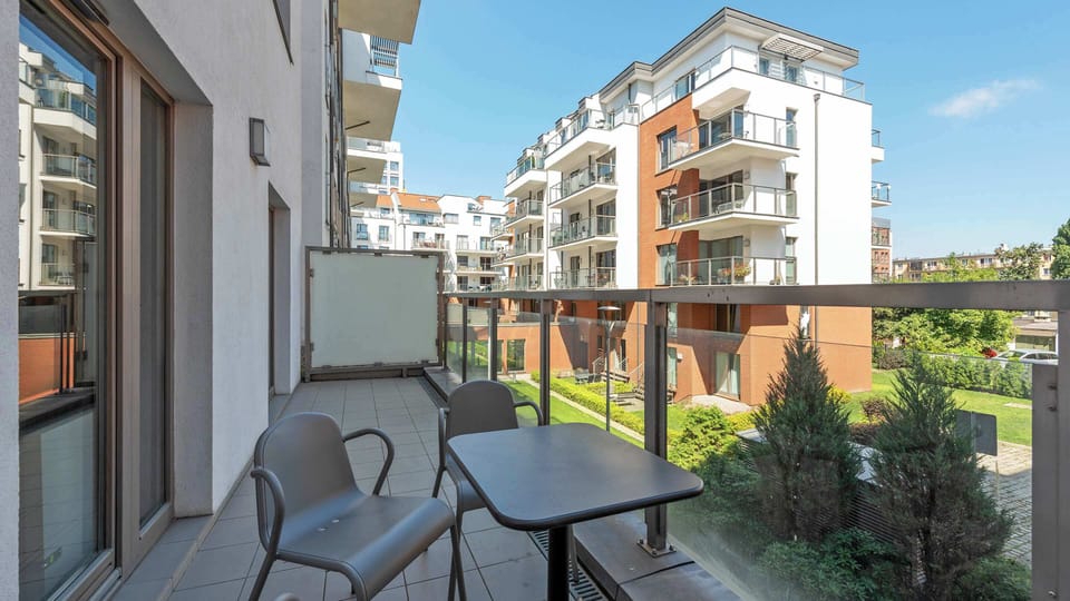 Balcony with garden furniture and a view of the estate.