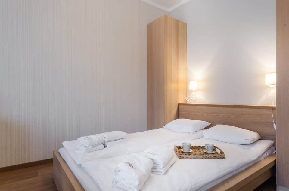 Minimalist lamps and delicate decorations create a cozy ambiance. This space is perfect for peaceful relaxation after a full day.