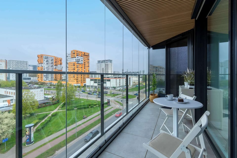 A private balcony with outdoor seating and beautiful green views.