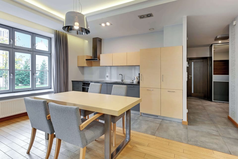 An elegant dining space with a table and upholstered chairs, seamlessly integrated with a contemporary kitchen design.