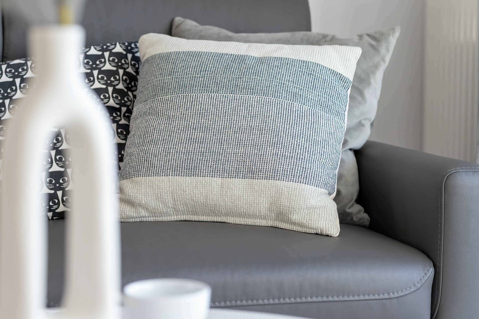 A close-up of a sofa decorated with pillows, adding a touch of sophistication.