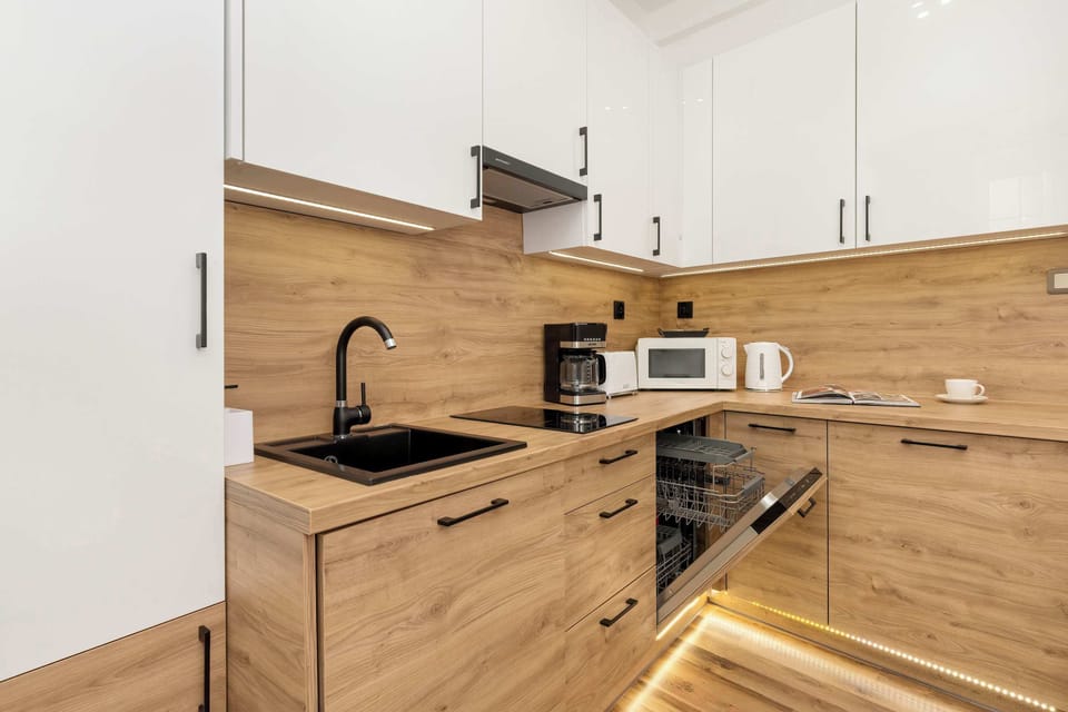 The kitchen has appliances such as a microwave, dishwasher and coffee machine.
