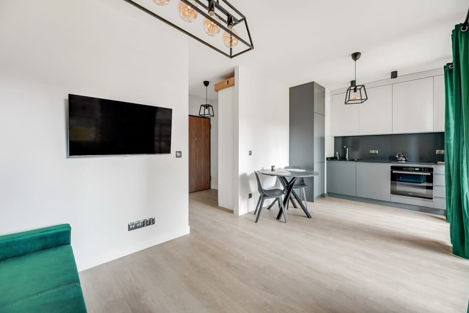 A suspended, large TV in a living room with an annex is a space-saver, but also a convenience.