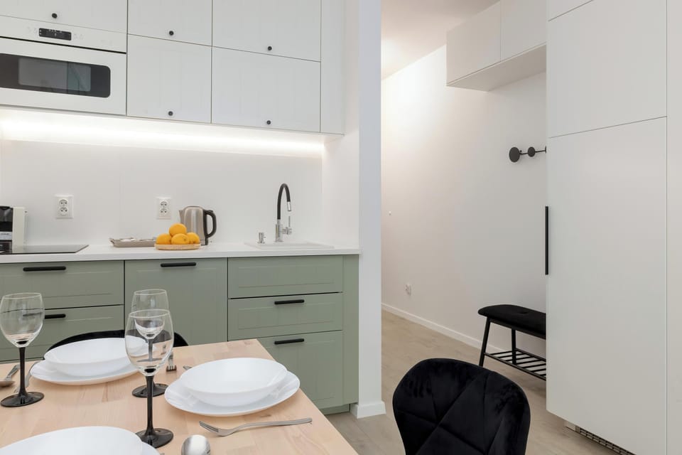 A closer shot of the kitchenette and dining area, with a small table set for two, offering an intimate and comfortable space for meals.