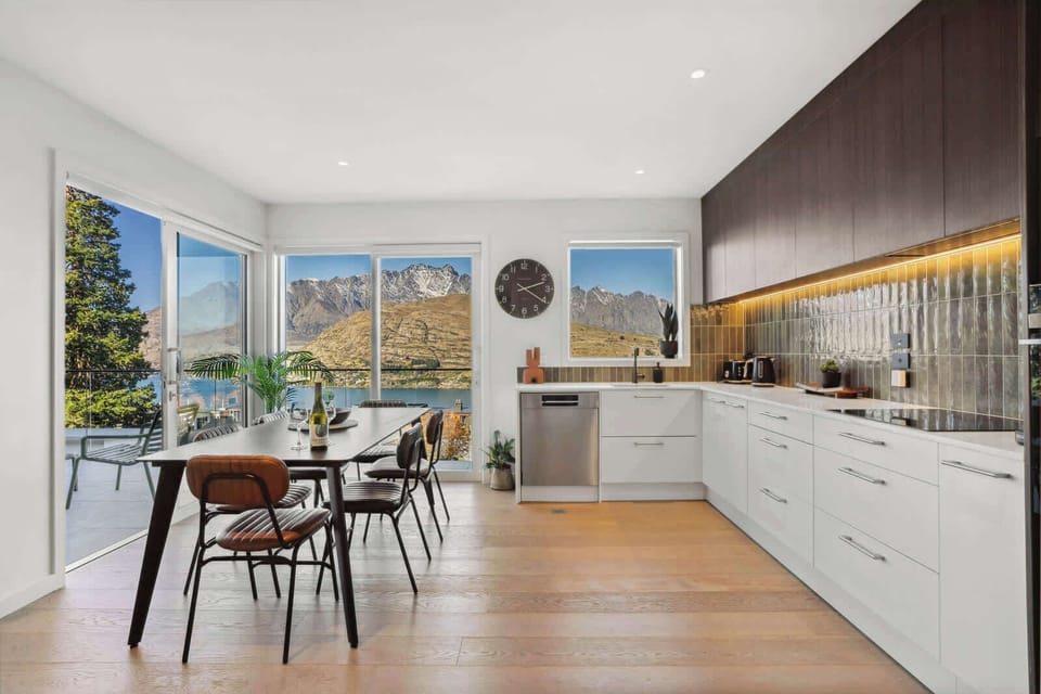 Stylish open-plan kitchen and dining area with breathtaking mountain and lake views—perfect for enjoying meals with a view or entertaining in comfort.