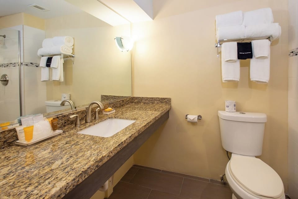 Refresh at the granite vanity with plush towels and amenities.