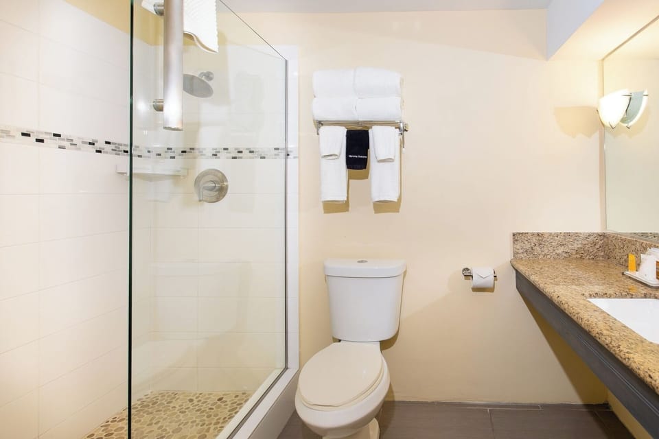 Refresh under a clean glass shower after beach days.