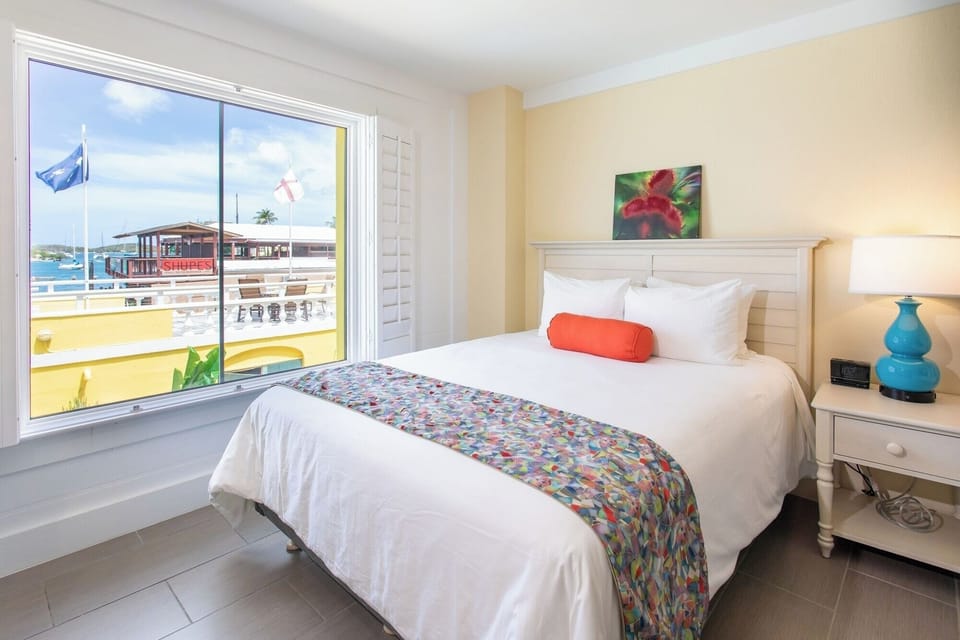 Wake up to sunlit comfort and sparkling harbor views.