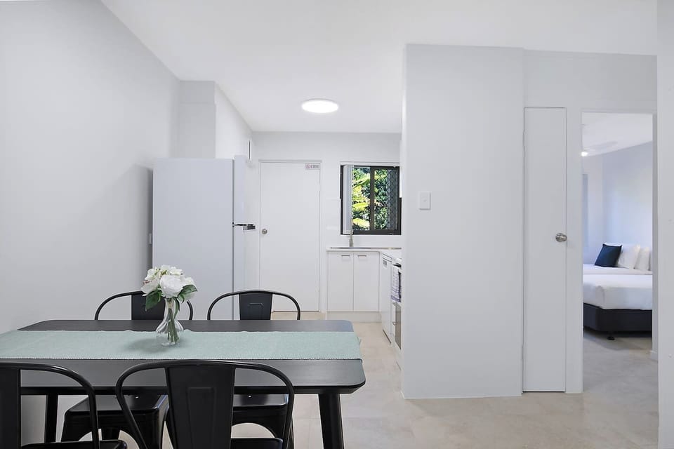 Gather for shared meals at the four-seater dining table, ideally positioned between the kitchen and lounge for a sociable setting.