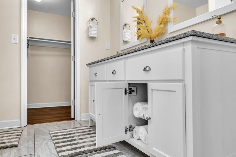 En Suite Bathroom | Features dual vanities, granite countertops, and a walk-in closet.