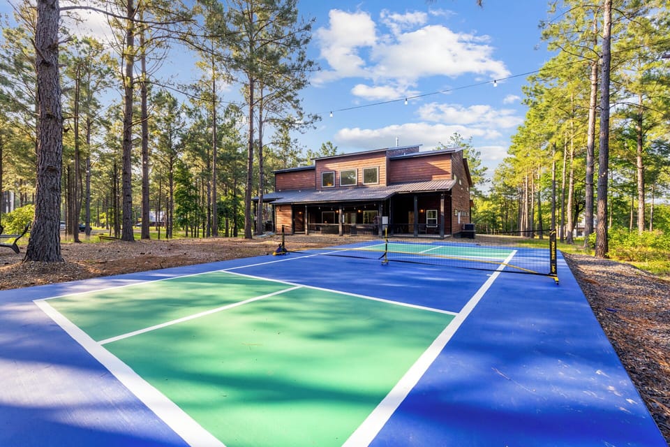 Serve up fun surrounded by towering pines! This private pickleball court brings friendly competition and fresh air right to your backyard—just steps from the cabin.